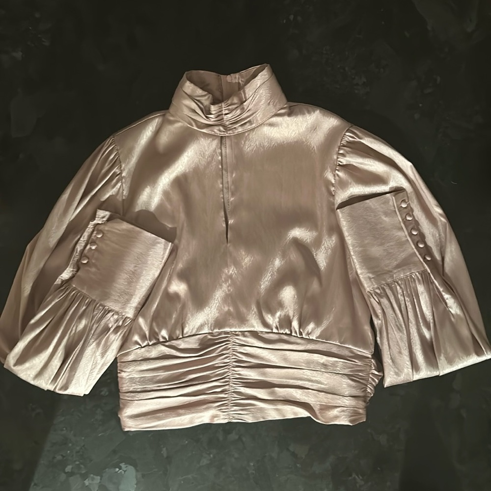 This is a INA long sleeve shirt. It is a size medium and it is a light pink